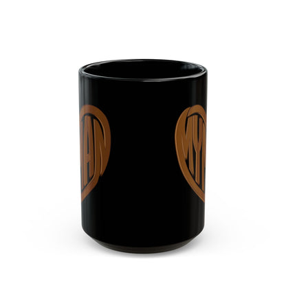 A glossy black ceramic mug featuring a wood look heart design on the sides, shown against a plain white background.