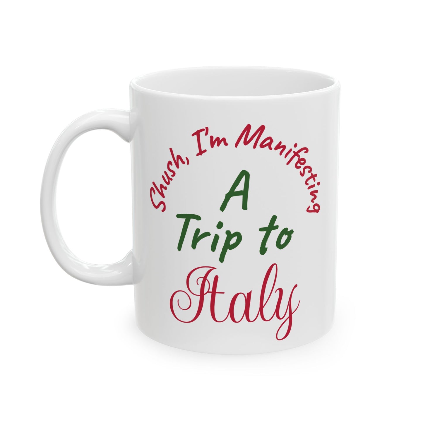 White mug with text 'Shush, I'm Manifesting A Trip to Italy' in red and green on a white background