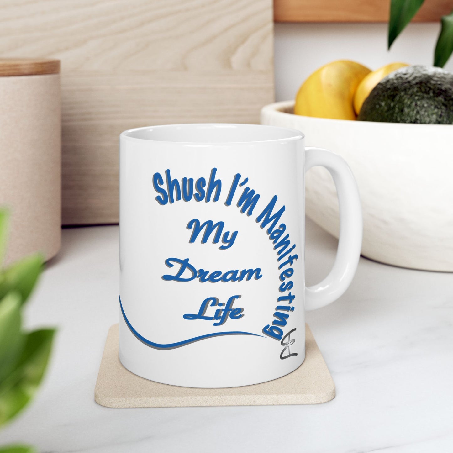 White ceramic mug with the text 'Shush, I'm Manifesting My Dream Life'

