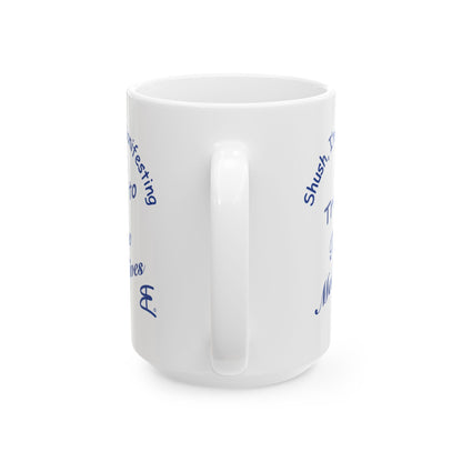 A white ceramic coffee mug with blue text printed on the side, shown from a three-quarters angle against a plain white background.