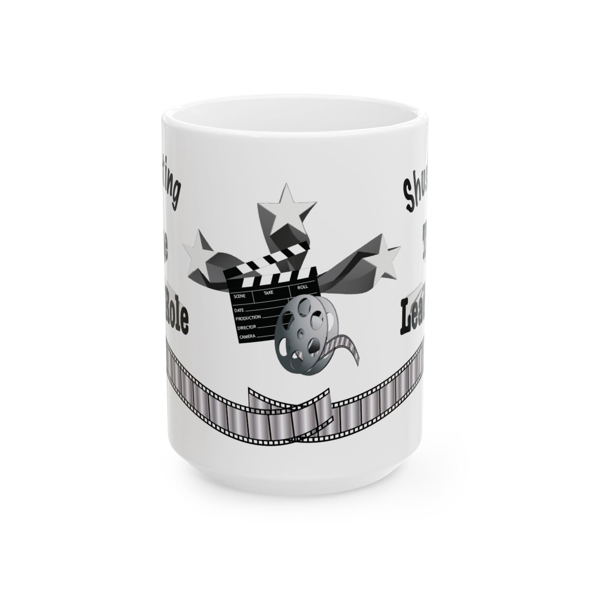 A white ceramic mug featuring a black and gray graphic design with a clapperboard, stars, film reel, and filmstrip motif, shown on a plain white background.