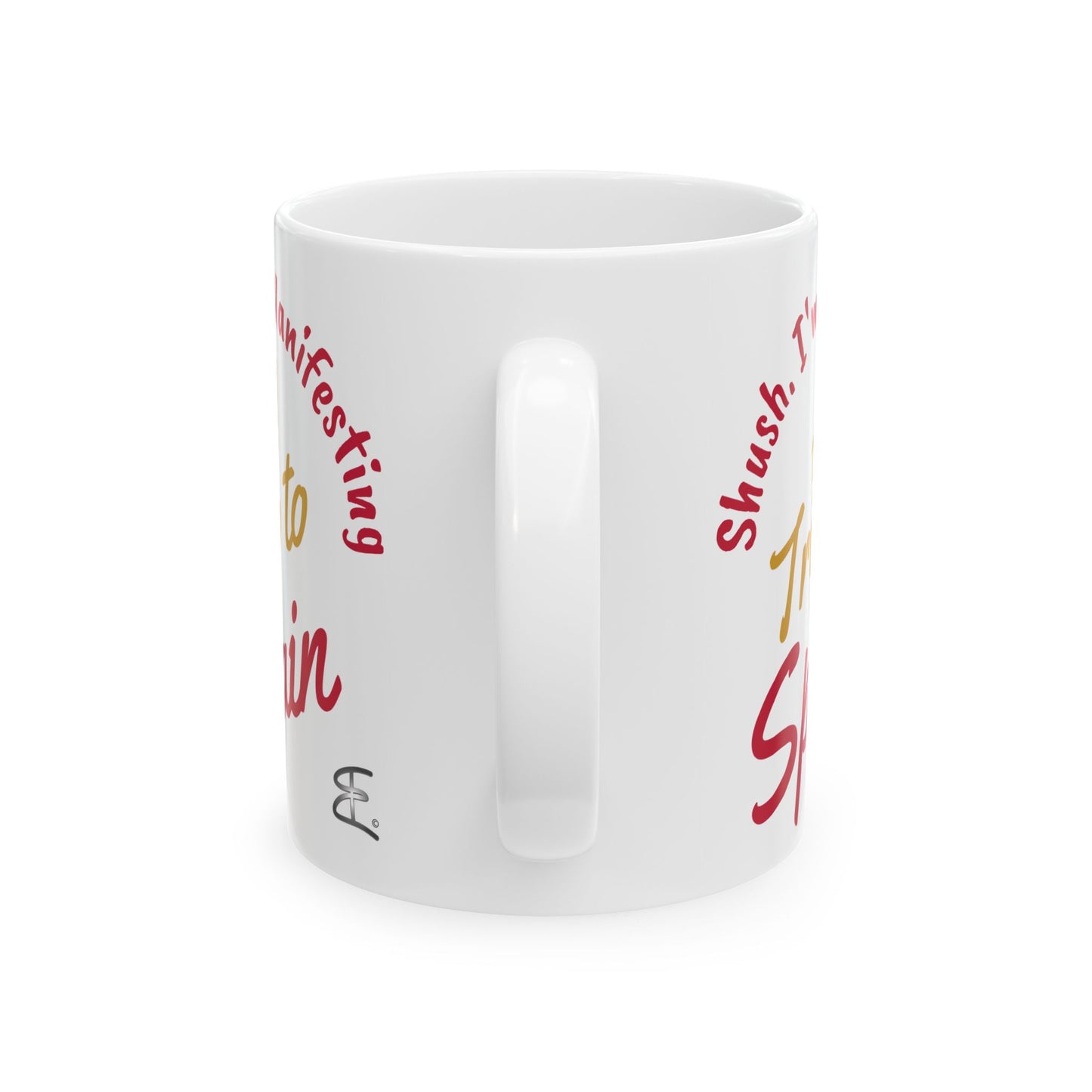 'Shush I'm Manifesting A Trip to Spain'  ceramic mug handle back view on white background.