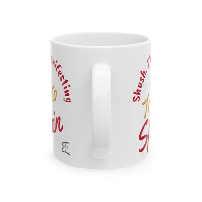 'Shush I'm Manifesting A Trip to Spain'  ceramic mug handle back view on white background.