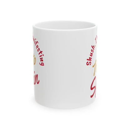 'Shush I'm Manifesting A Trip to Spain' ceramic mug front center view on white background.