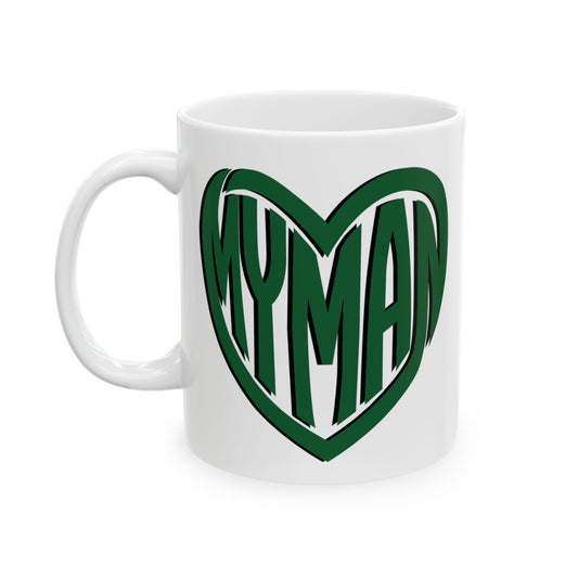A white ceramic mug featuring a green heart-shaped graphic with the word 'MYMAN' in bold green letters outlined in white, set against a plain white background.