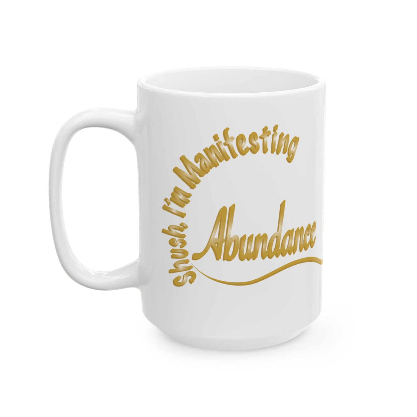 A white ceramic coffee mug with a gold foil-style printed quote that reads 'shush I'm Manifesting Abundance' in an arched, script-like design, shown on a plain white background.