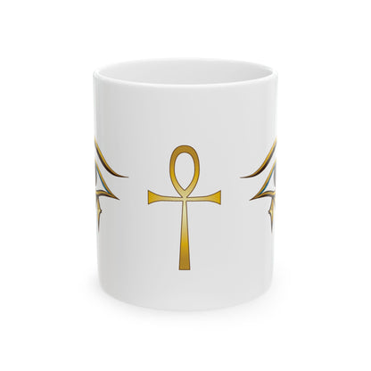 A white ceramic mug featuring a gold Egyptian ankh symbol printed on the front, flanked by stylized gold wing-like motifs on either side, set against a plain white background.
