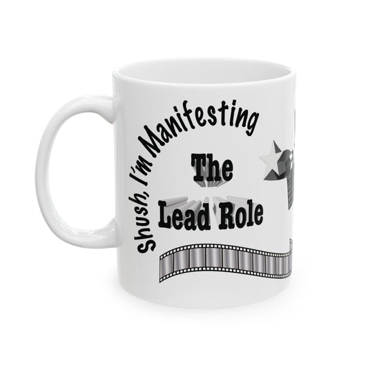 White ceramic mug with the text 'Shush, I'm Manifesting, The Lead Role.