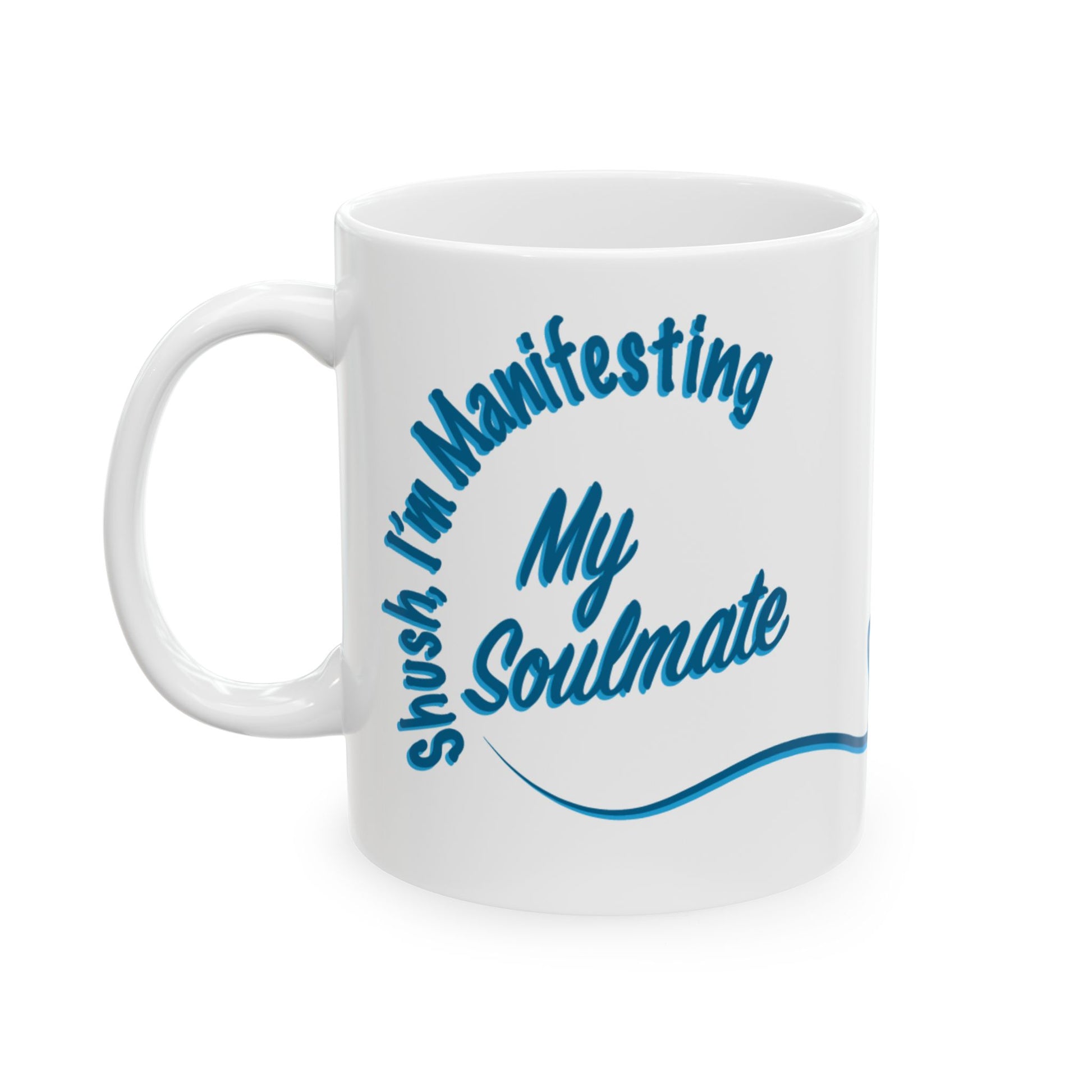 A white ceramic coffee mug with blue text reading 'Shush I'm Manifesting My Soulmate' great for that friend who's always look for their person.