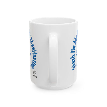 A white 15oz ceramic coffee mug with blue text printed on the sides, back or handle view shown against a plain white background.