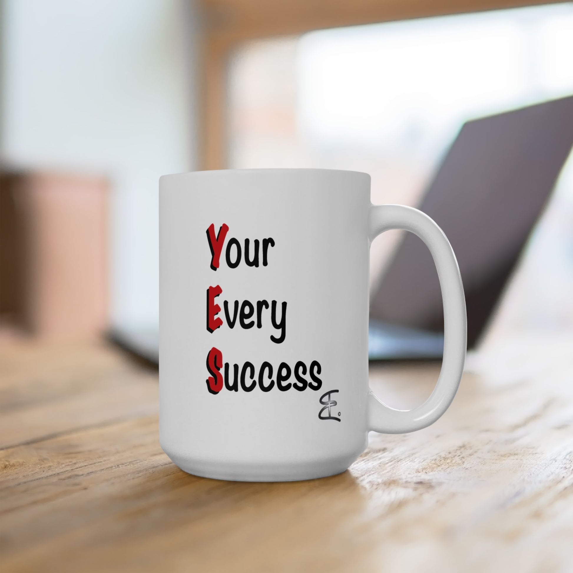 YES coffee mug displayed on a desk beside office accessories, featuring bold red lettering on a white ceramic mug.