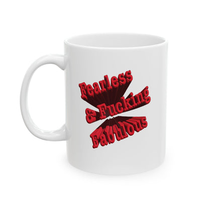A white ceramic mug with a red graphic text that reads 'Fearless & Fucking Fabulous' handle of left on a  white background.