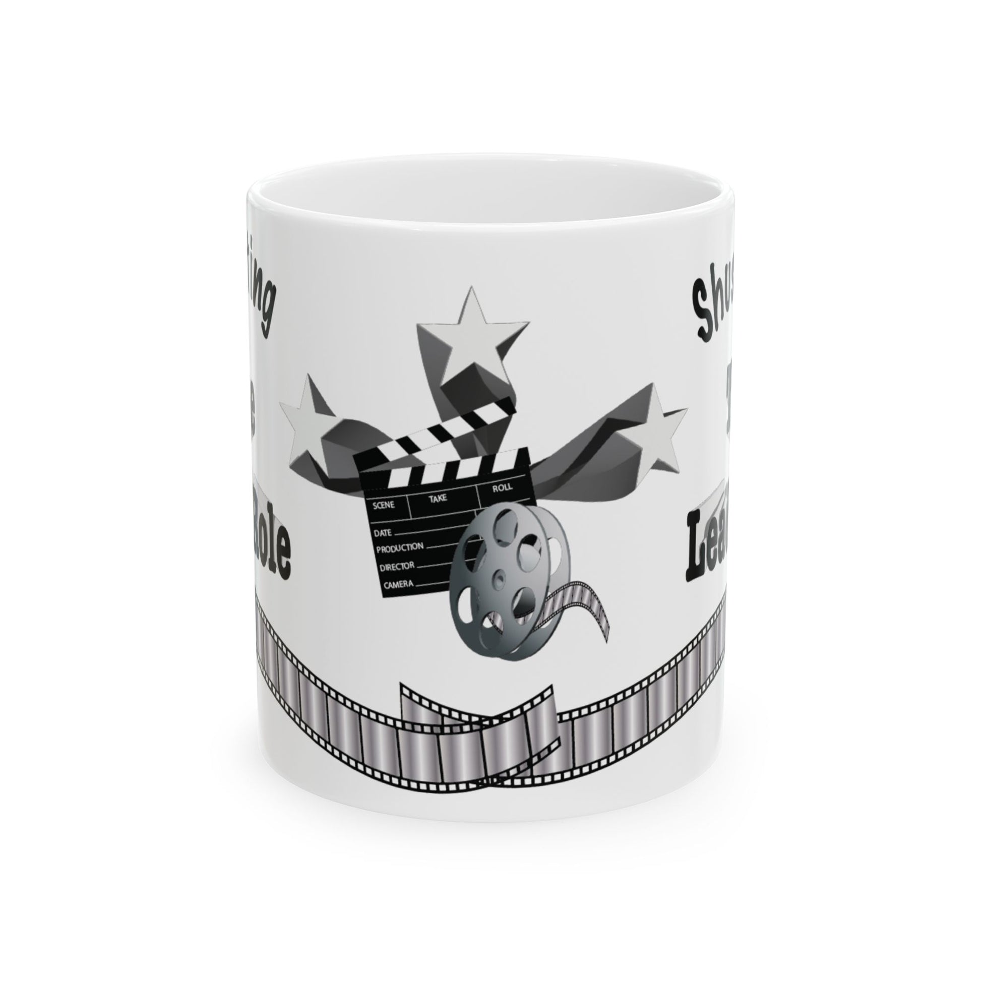A white ceramic mug featuring a black and gray graphic design with a clapperboard, film reel, stars, and a film strip, with partial text showing.