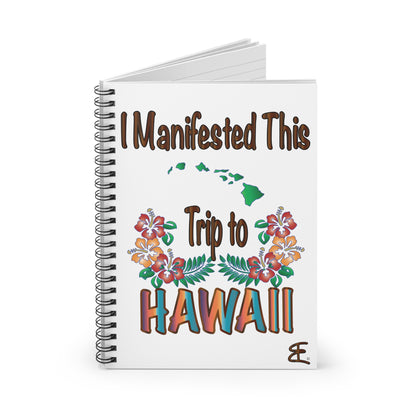 A white spiral-bound notebook with a colorful graphic on the cover that reads 'I Manifested This Trip to HAWAII' with floral illustrations and green Hawaii state silhouettes, shown on a clean white background.