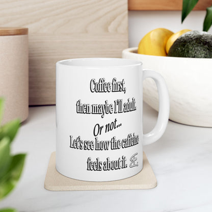 White ceramic coffee mug that says “Coffee First... Then Maybe I'll Adult” white mug sitting on a coaster.