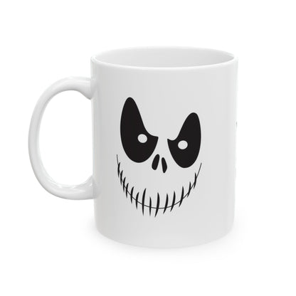 A white ceramic mug featuring a black graphic of a spooky cartoon face with large eyes and a stitched grin, shown on a plain white background.
