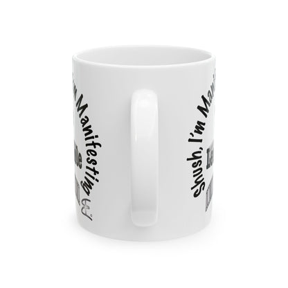 A white ceramic mug with a black printed graphic and text on the side, shown against a plain white background.