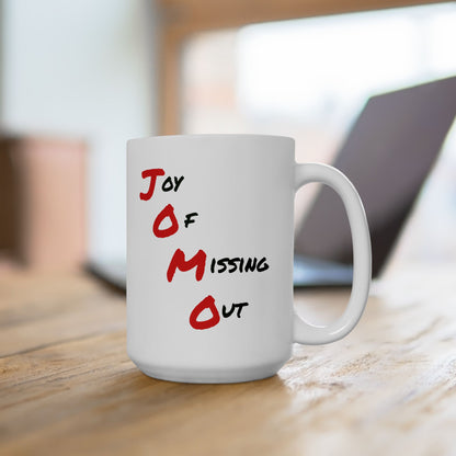 Sarcastic 15oz mug with big red letters "JOMO" and "Joy of Missing Out" on desk with laptop in background.
