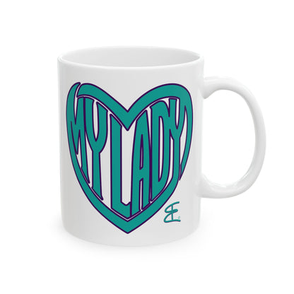 A white ceramic coffee mug featuring a teal and purple heart graphic with the text 'MY LADY' inside, on a clean white background.