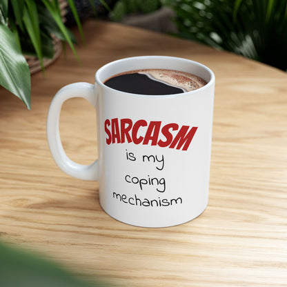 Double-sided sarcastic mug that says "Sarcasm is my coping mechanism" on wood desk.

