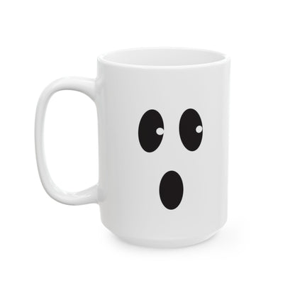 A white ceramic mug with a black cartoon face graphic on the front, photographed on a clean white background.