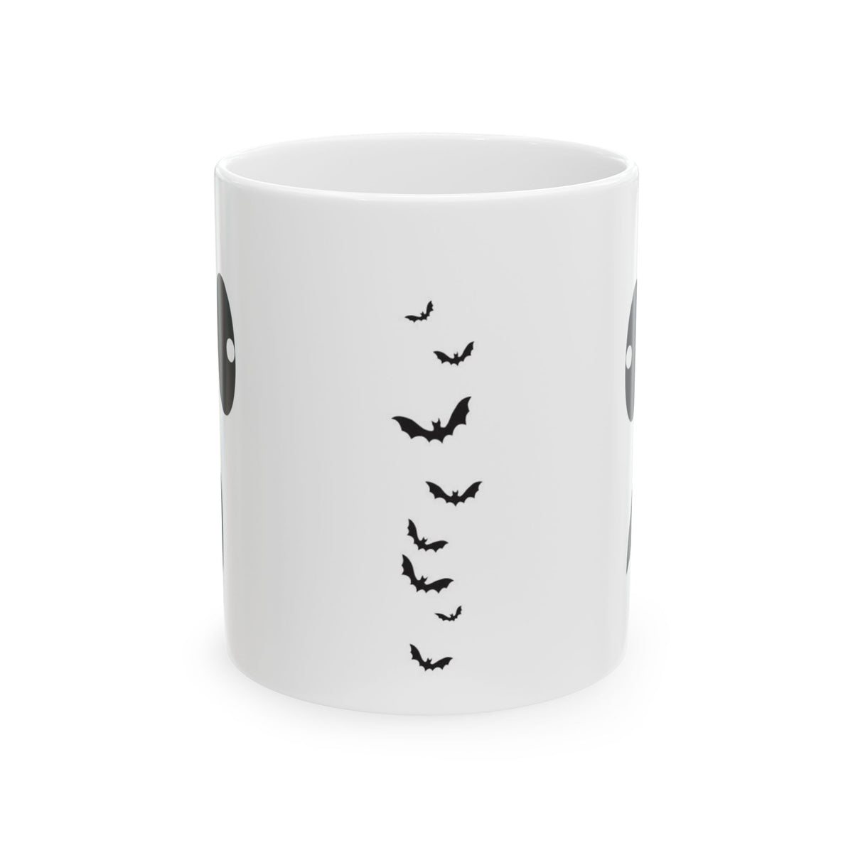 A white ceramic mug featuring a black graphic print of flying bats and partial circular eye designs on the sides, shown against a plain white background.