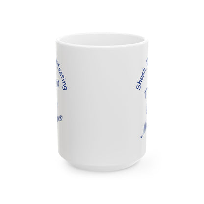 A white ceramic mug with blue text and graphic elements partially visible on the side, shown against a plain white background.