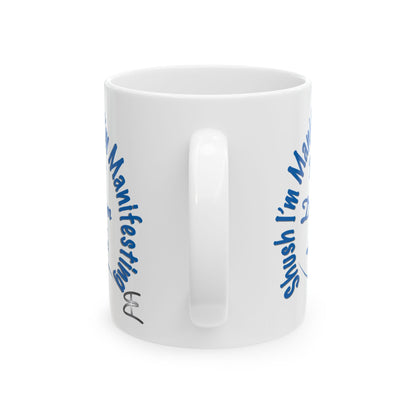 White ceramic mug with the text 'Shush, I'm Manifesting My Dream Life'

