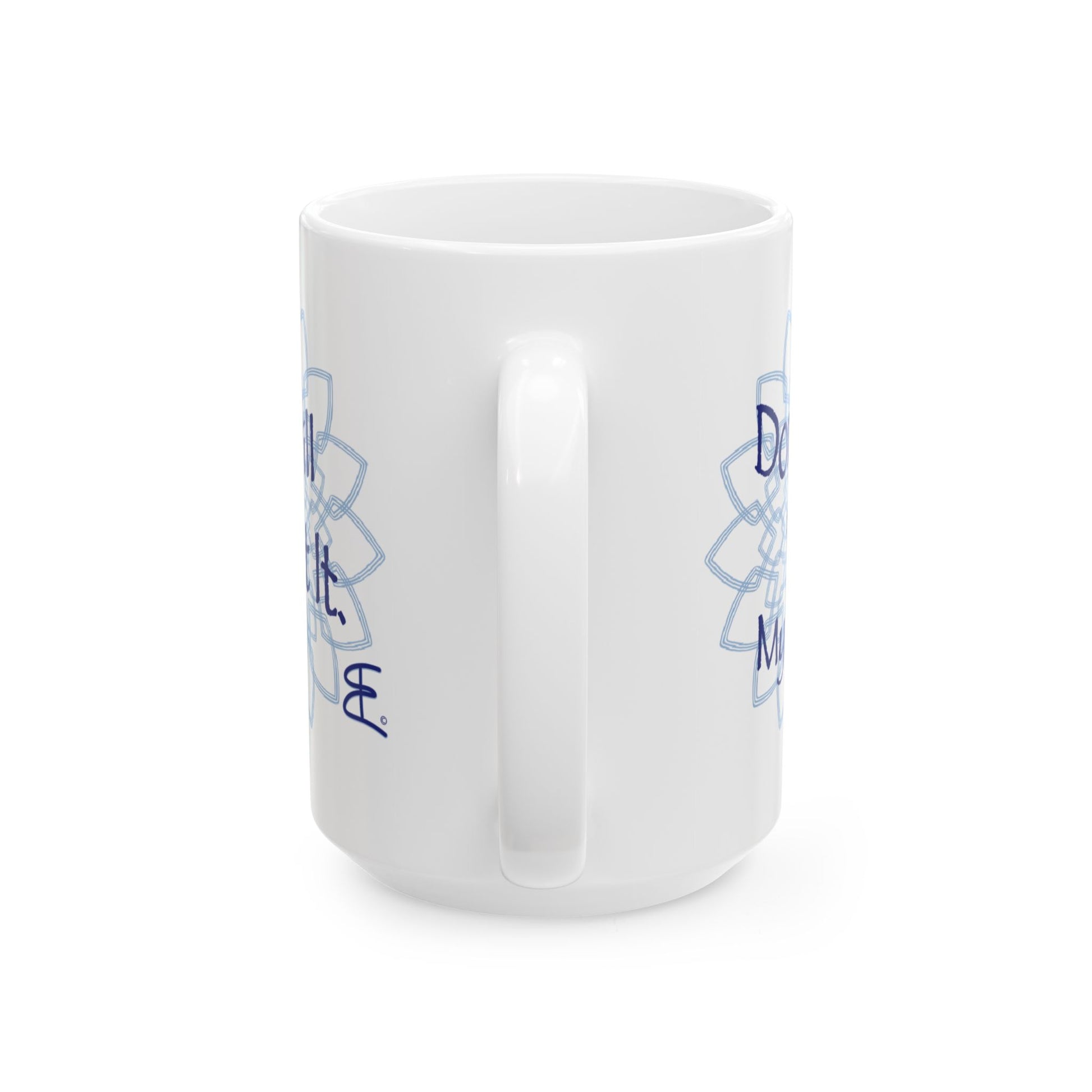 White ceramic mug, angled front view with light blue mandala artwork and partial blue text.