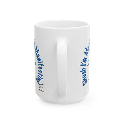 White ceramic mug with the text 'Shush, I'm Manifesting My Dream Life'

