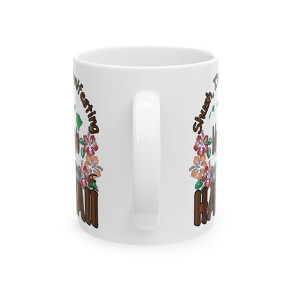 A white ceramic mug with a colorful graphic design featuring brown text and floral illustrations, shown on a clean white background.
