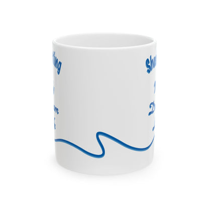 A white ceramic mug with blue printed text and a wavy line design, shown on a clean white background.