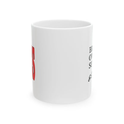 A white ceramic mug with partial red and black printed text visible on the side, photographed on a clean white background.