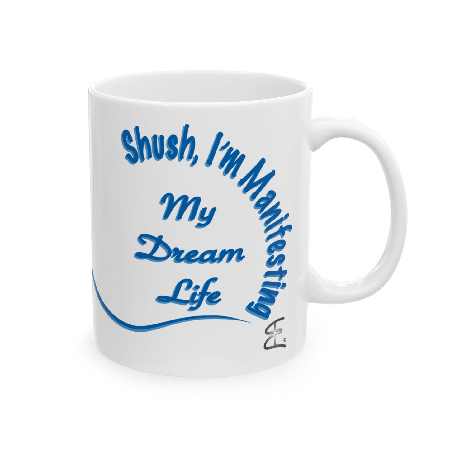 A white ceramic mug with blue text reading 'Shush, I'm Manifesting My Dream Life' and a blue curved line, shown on a plain white background.