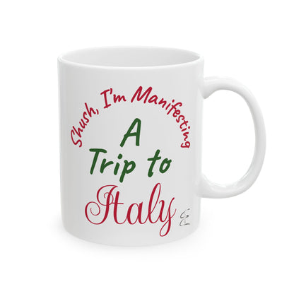 White mug with text 'Shush, I'm Manifesting A Trip to Italy' on a white background