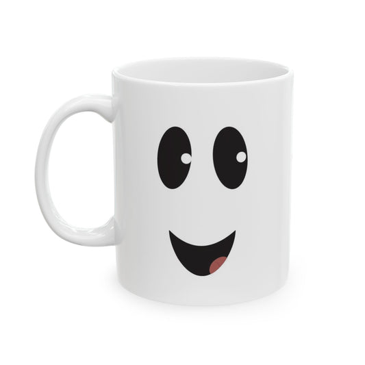 A white ceramic mug featuring a ghost face with large eyes and a smiling mouth showing a small pink tongue, set against a plain white background.
