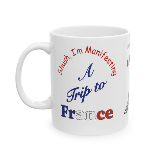 White mug with text 'Shush, I'm Manifesting A Trip to France' on a white background