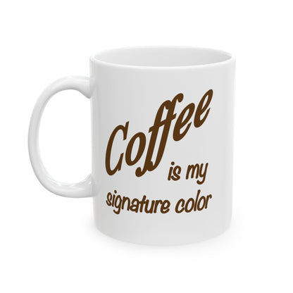 A white ceramic coffee mug with brown text that reads 'Coffee is my signature color' on a clean white background.