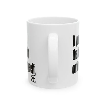 A white ceramic mug with black printed text partially visible on the side, shown against a plain white background.