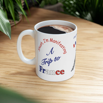 A Trip to France Ceramic Mug — 'Shush I'm Manifesting' Coffee Cup (11oz & 15oz)
