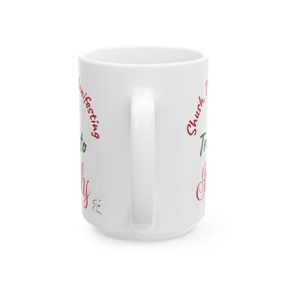 White mug with red and green text on a white background