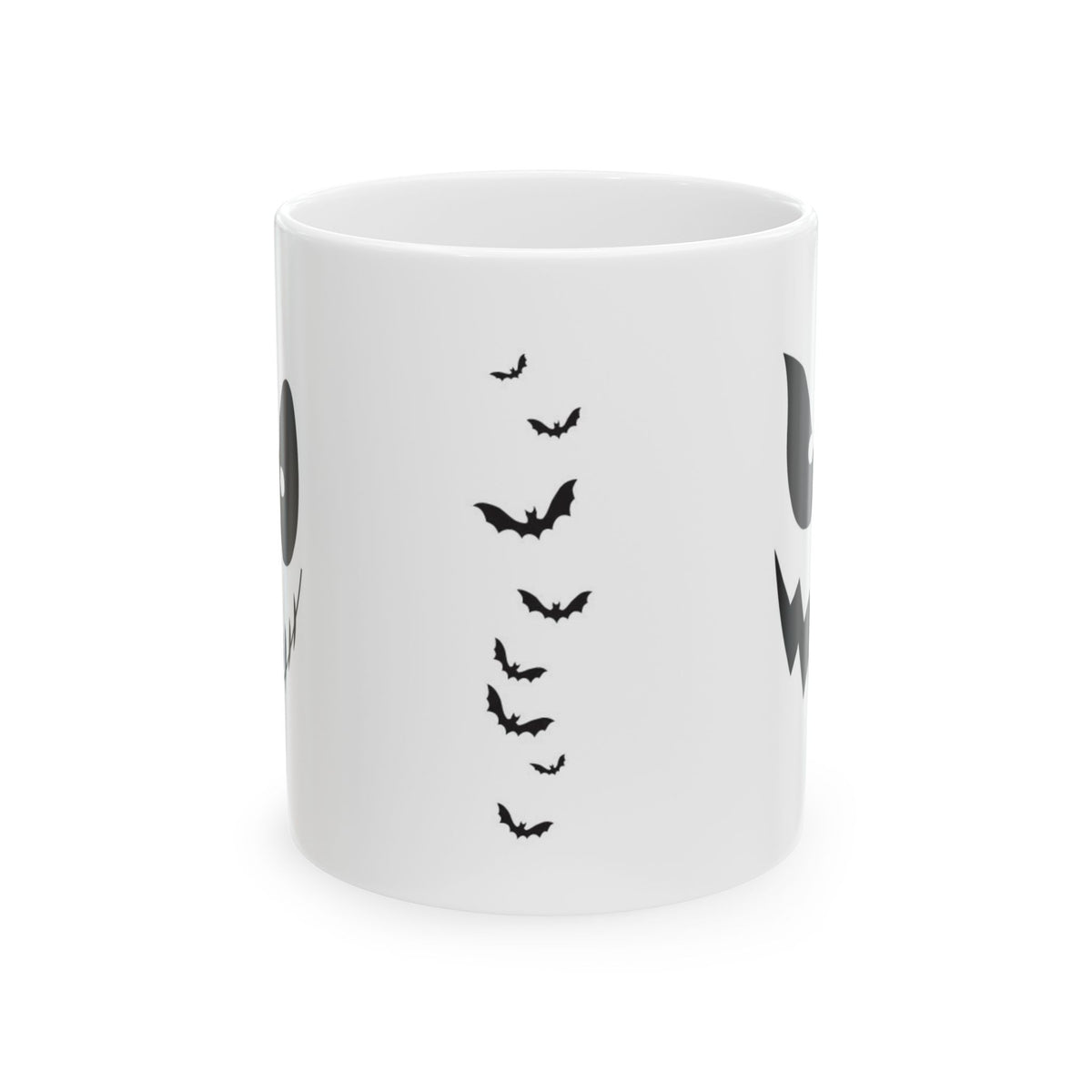 A white ceramic mug featuring a black graphic print of flying bats and partial ghost designs on the sides, shown against a plain white background.
