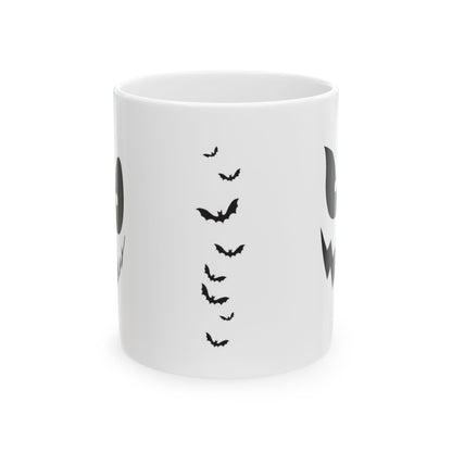 A white ceramic mug featuring a black graphic print of flying bats and partial ghost designs on the sides, shown against a plain white background.