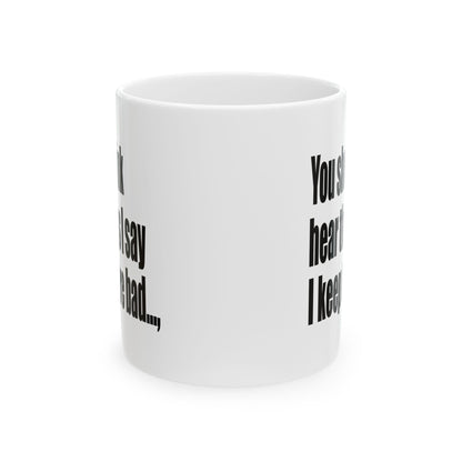 A white ceramic mug with black printed text on a clean white background.