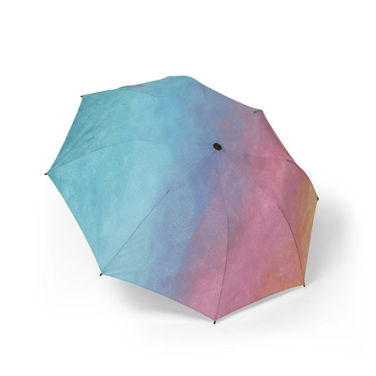 outside view of a Sunrise Gradient-colored umbrella sitting on the ground of a white background.