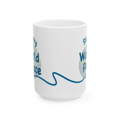 A white ceramic mug with a blue and light blue graphic design on the side, featuring partial text that reads Shush, I'm Manifesting World Peace. 